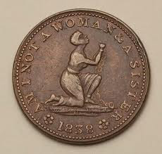 a medal engraved with the slogan of the abolitionist movement